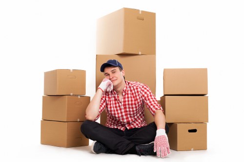 Removal crew handling packed office equipment during a commercial relocation